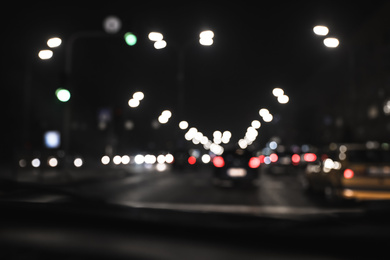 Photo of Blurred view of road with cars at night. Bokeh effect