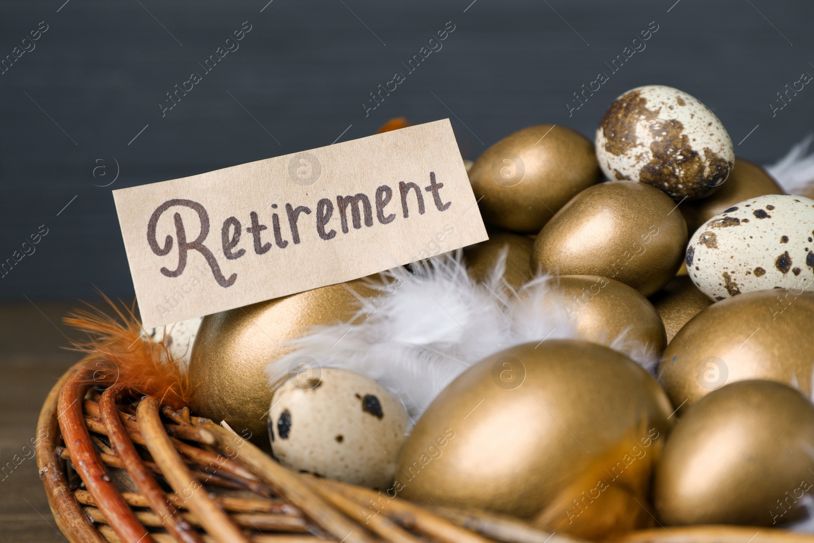 Photo of Card with word Retirement, many golden and quail eggs in nest, closeup. Pension concept