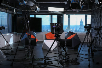 Photo of Modern video recording studio with professional cameras
