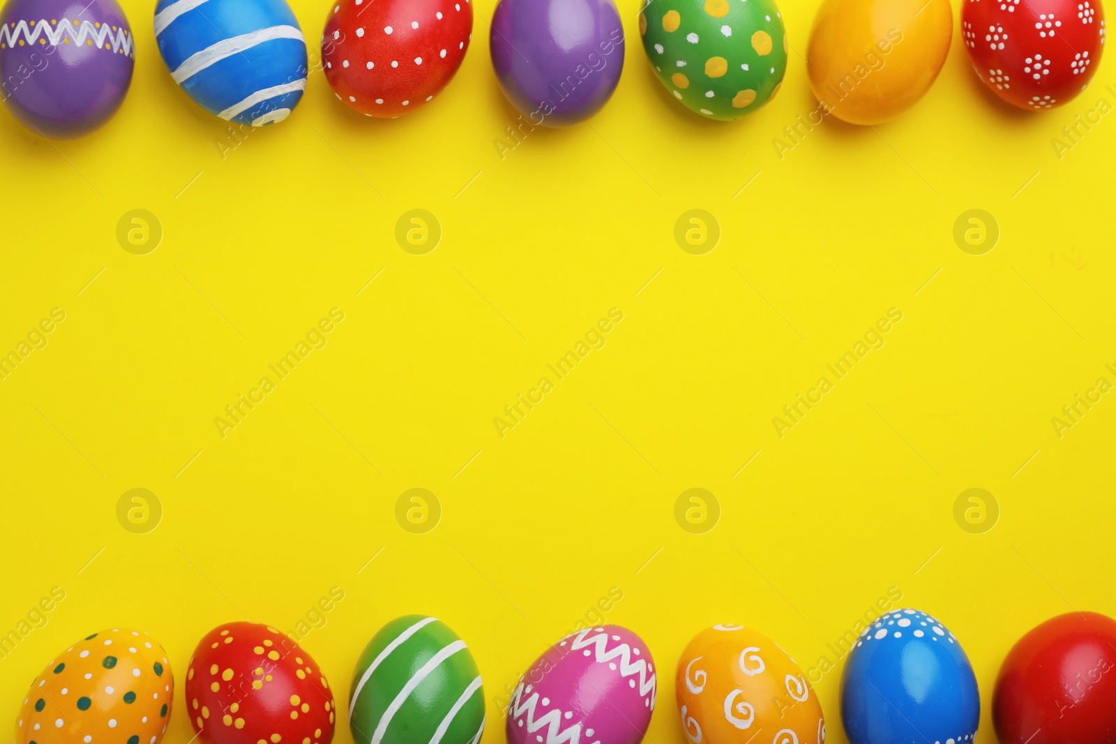 Photo of Decorated Easter eggs and space for text on color background, top view