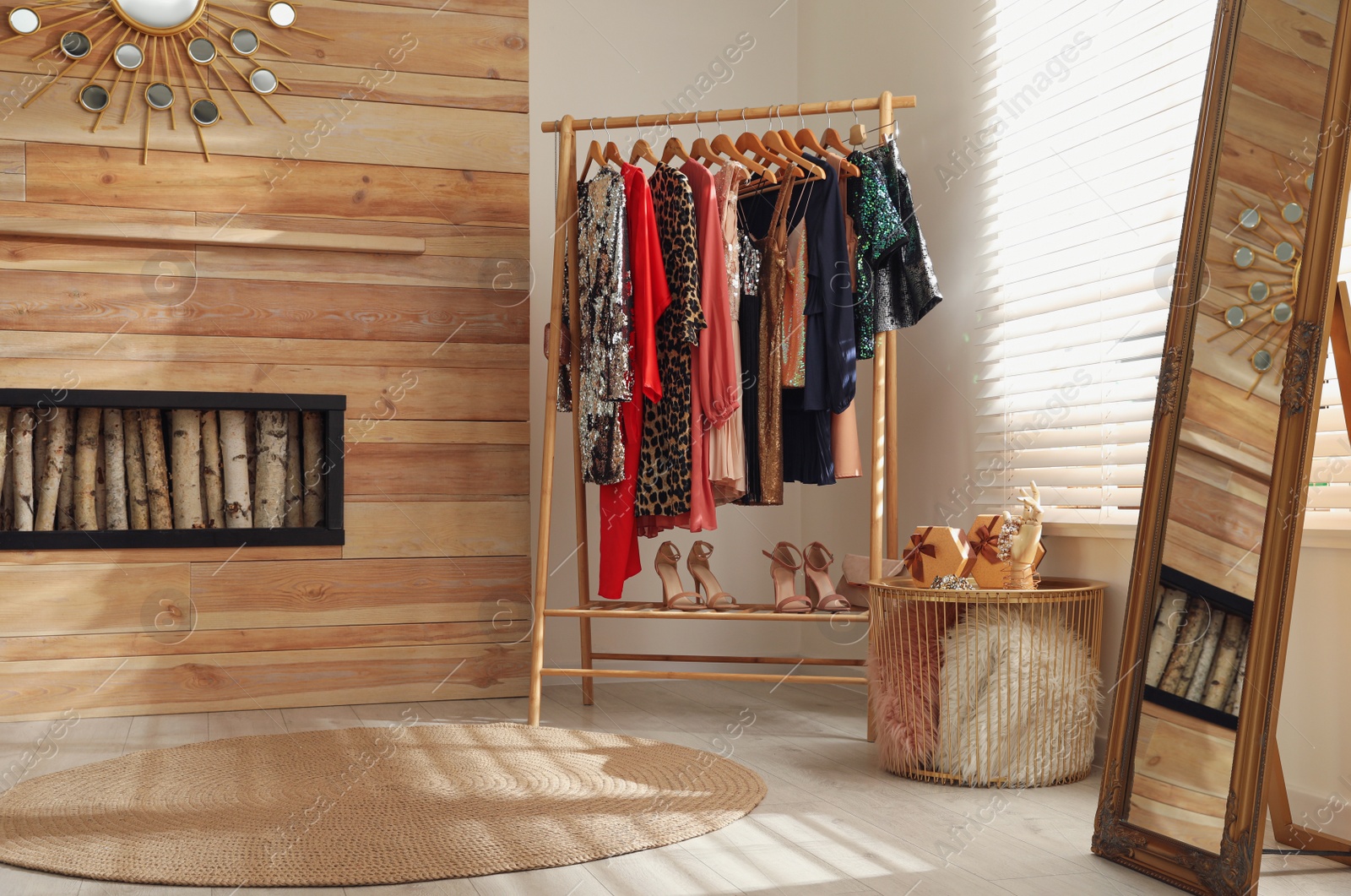 Photo of Rack with stylish women's clothes in room. Interior design