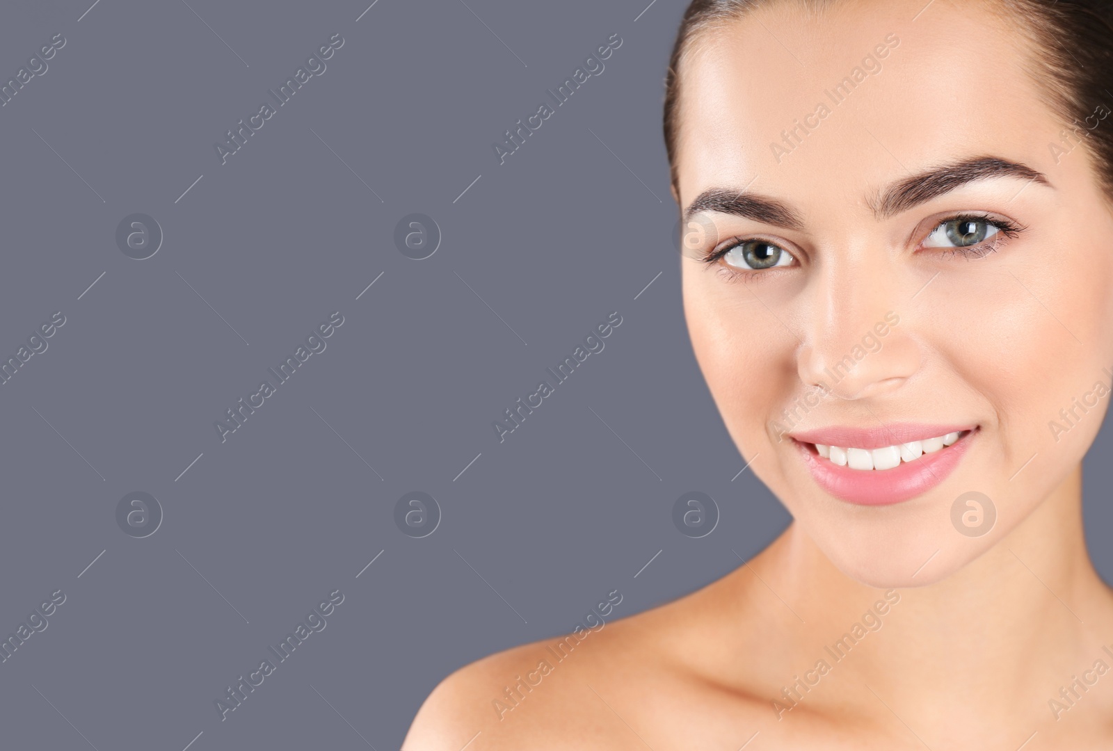 Photo of Portrait of beautiful young woman and space for text on grey background. Cosmetic surgery concept