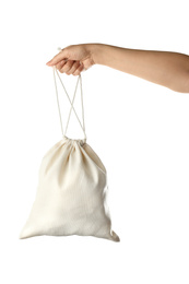 Photo of Woman holding full cotton eco bag on white background, closeup
