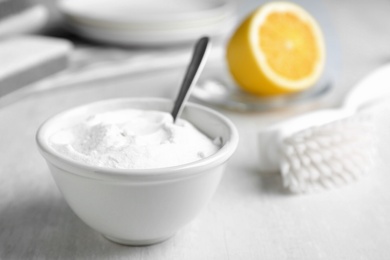 Photo of Bowl of baking soda on white table, space for text