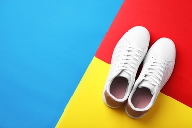 Pair of sneakers on color background, flat lay. Space for text