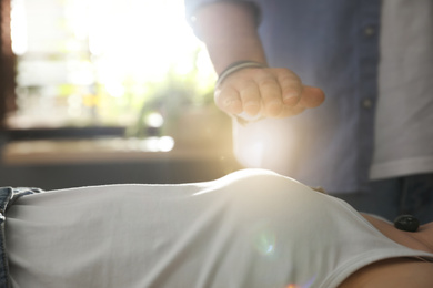 Young woman during crystal healing session in therapy room, closeup