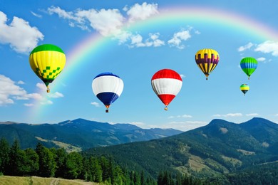 Bright hot air balloons flying over mountains