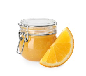 Delicious orange marmalade in glass jar and citrus fruit slice on white background