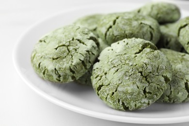 Photo of Plate with tasty matcha cookies on white table, closeup