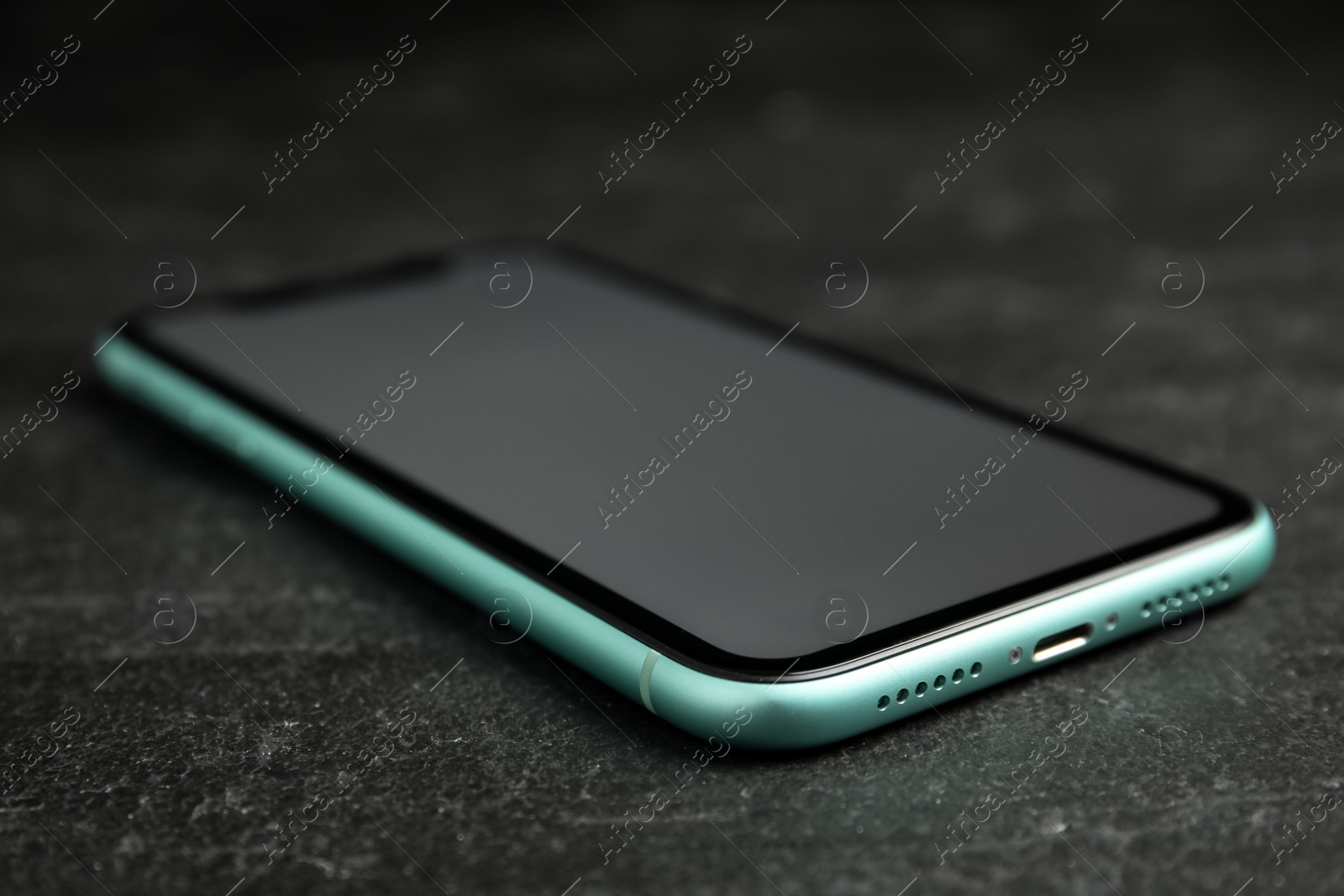 Photo of MYKOLAIV, UKRAINE - JULY 9, 2020: New modern Iphone 11 with blank screen on black background, closeup