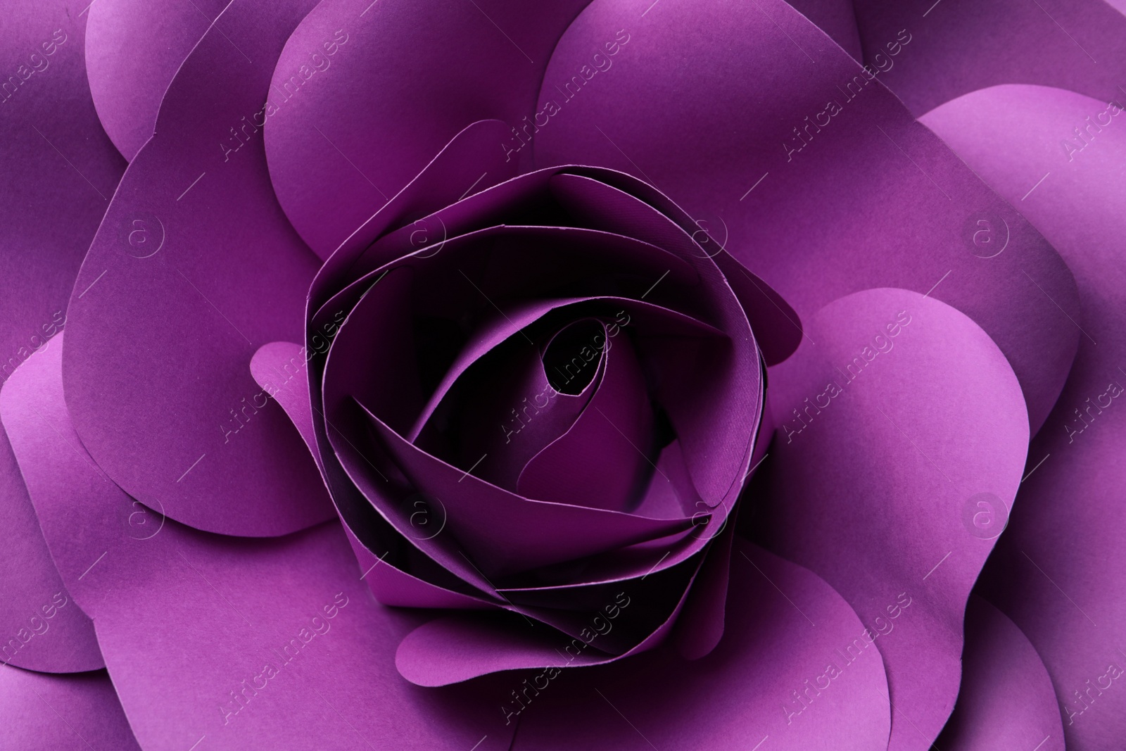 Photo of Beautiful purple flower made of paper as background, top view