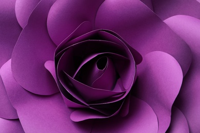 Beautiful purple flower made of paper as background, top view