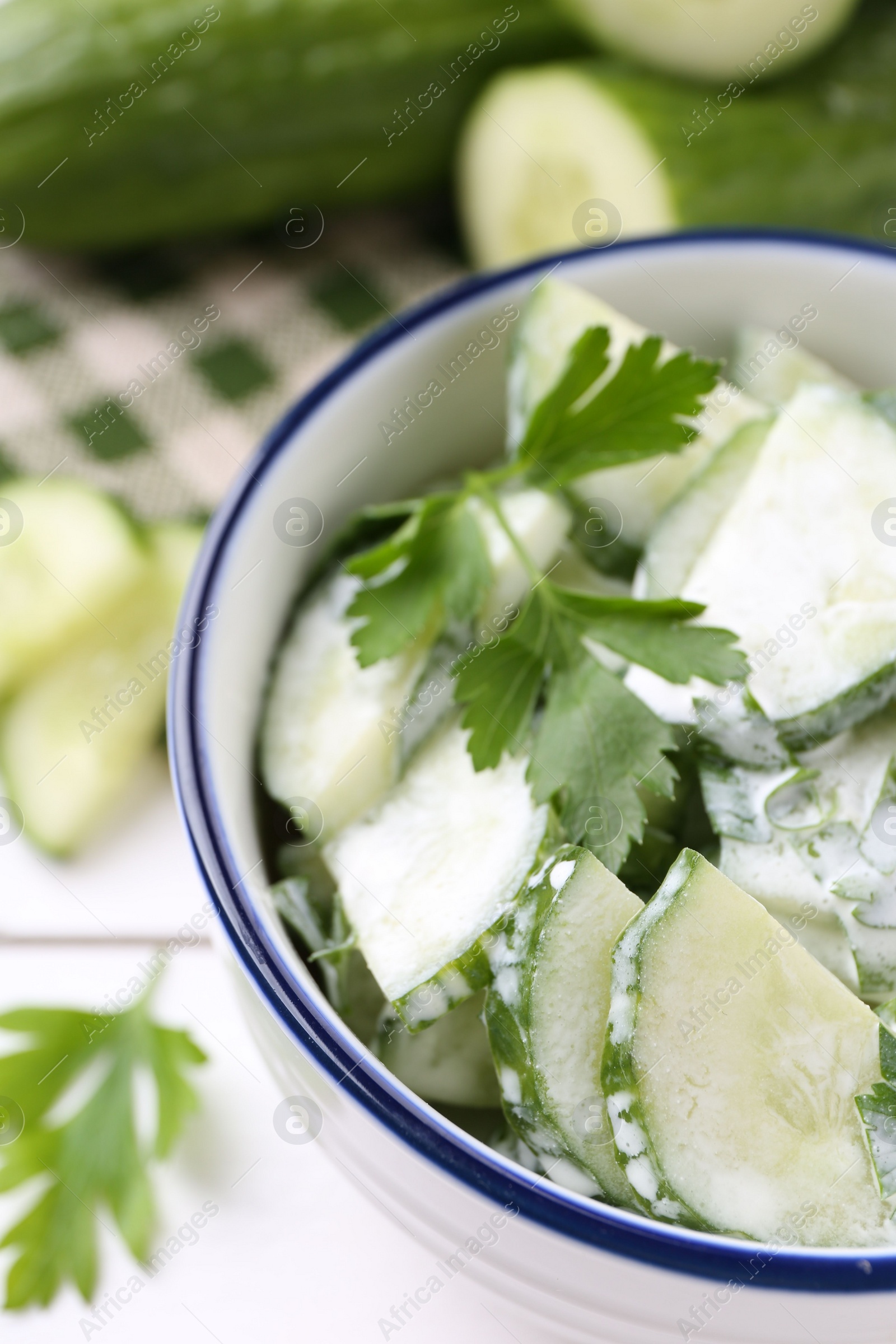 Photo of Delicious cucumber salad in bowl on table, closeup