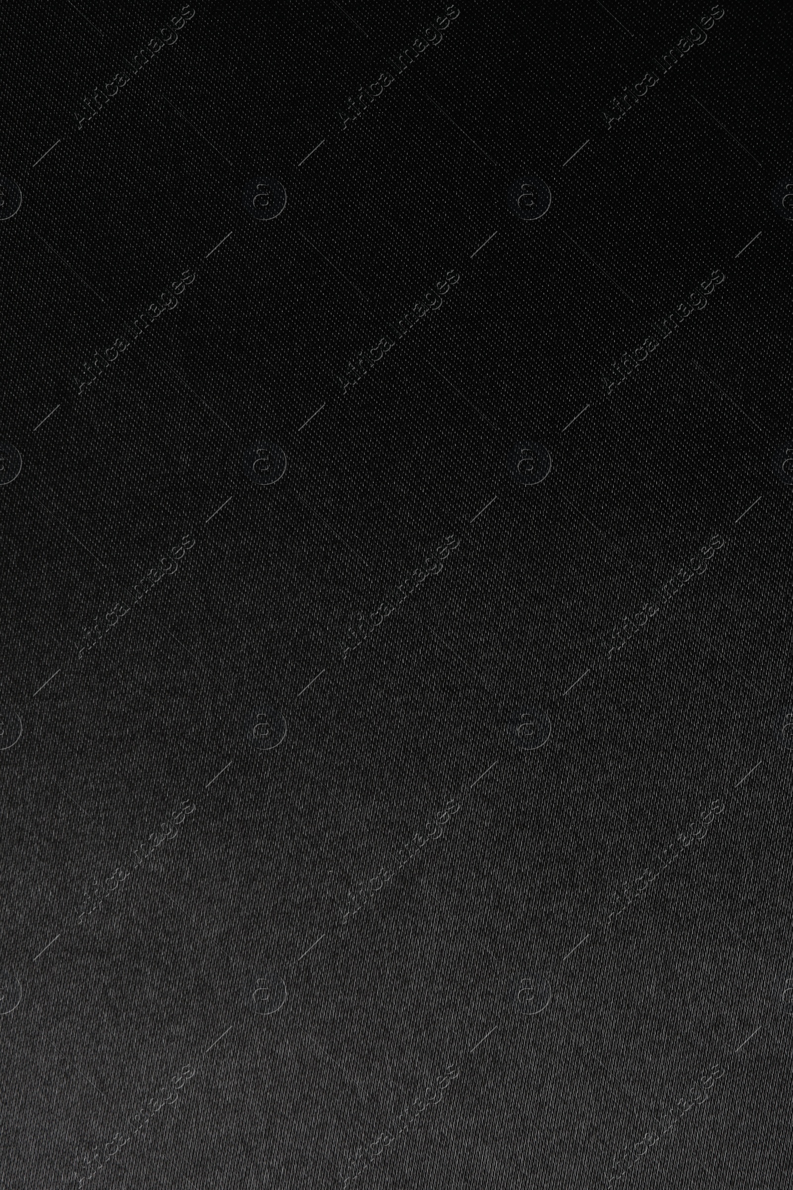 Photo of Texture of black silk fabric as background, top view