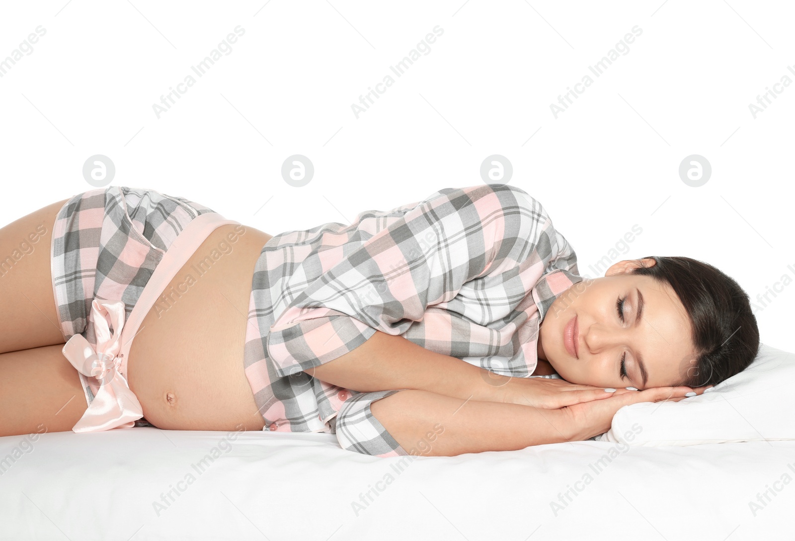 Photo of Beautiful pregnant woman sleeping with orthopedic pillow on bed against white background