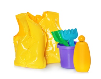 Photo of Inflatable vest and beach toys on white background