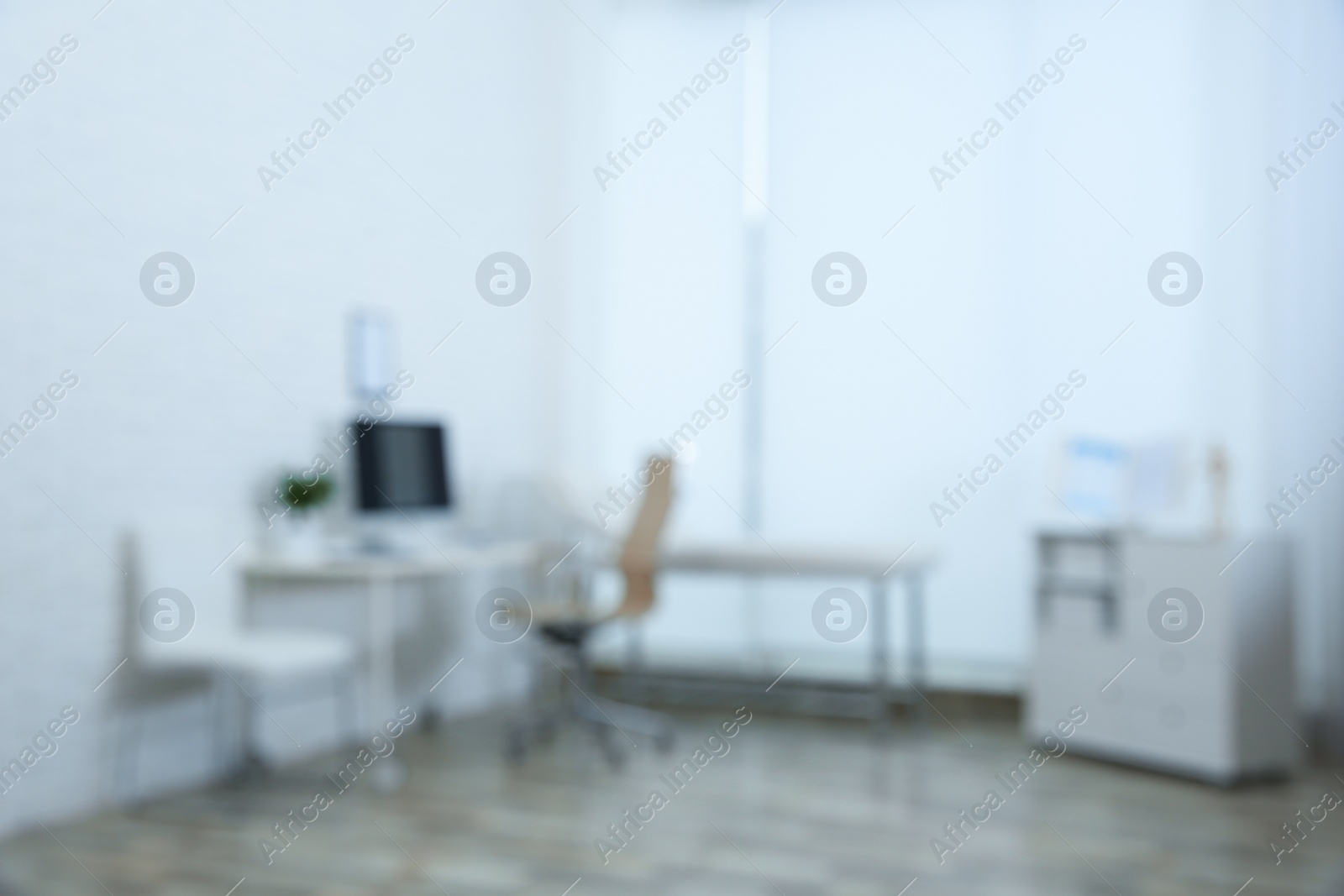 Photo of Blurred view of modern medical office. Doctor's workplace