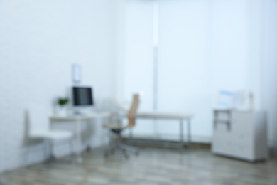 Photo of Blurred view of modern medical office. Doctor's workplace