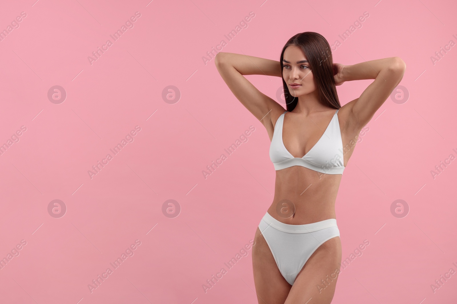 Photo of Young woman in stylish white bikini on pink background. Space for text