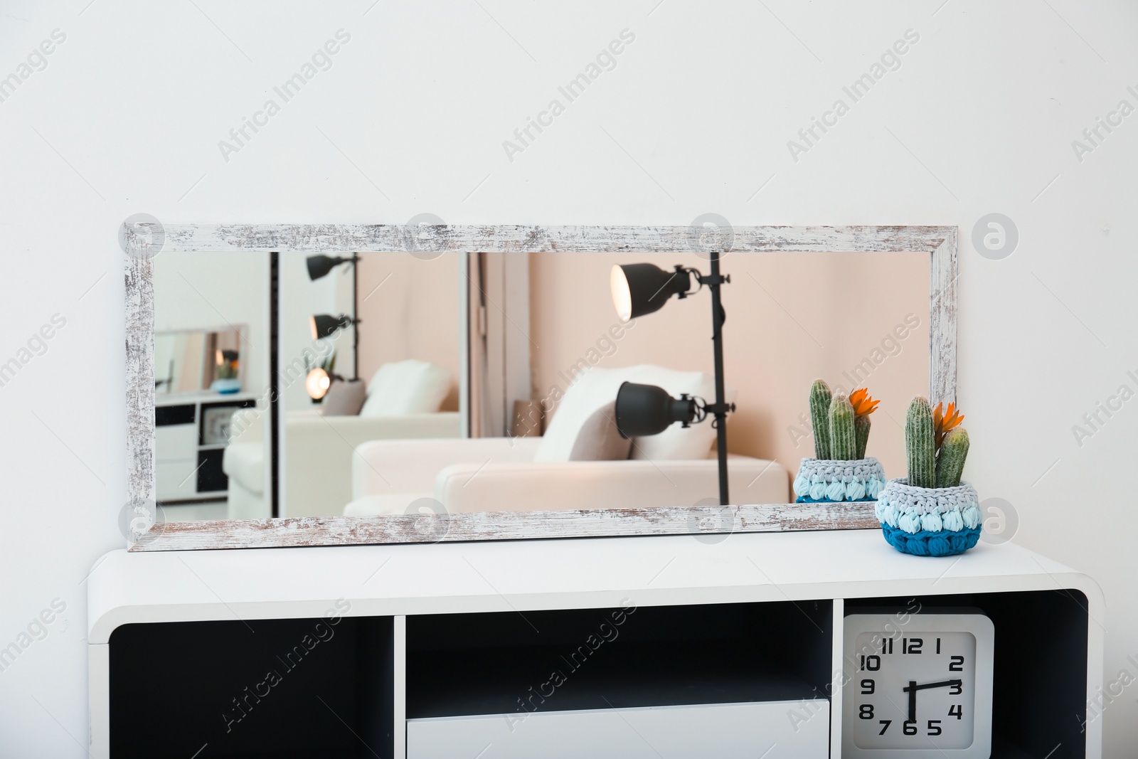 Photo of Wide mirror on table near light wall