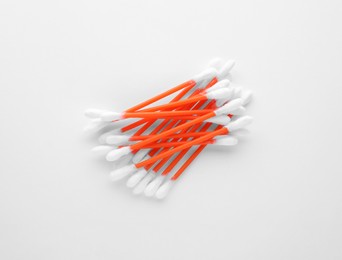 Photo of Heap of clean cotton buds on white background, top view