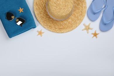 Flat lay composition with beach objects on white background, space for text