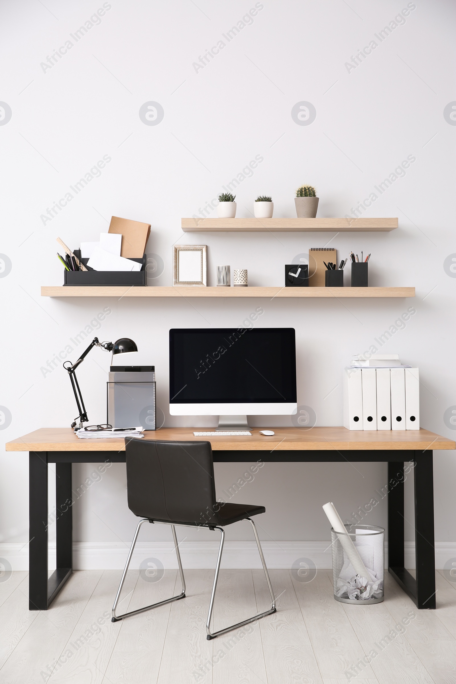 Photo of Modern computer on table in office interior. Stylish workplace