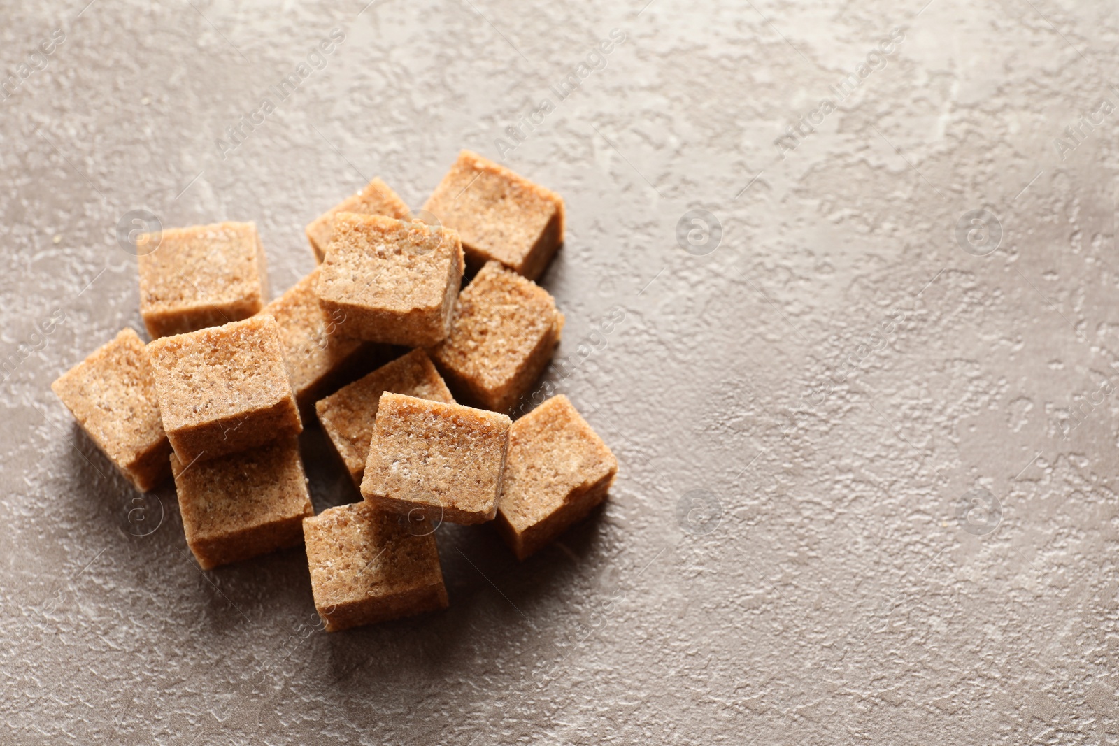 Photo of Cubes of brown sugar on table