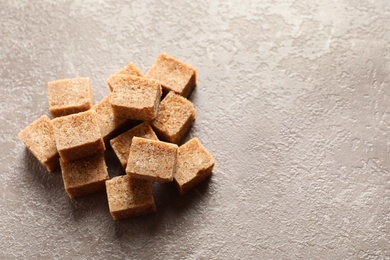 Cubes of brown sugar on table