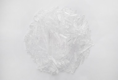 Photo of Heap of menthol crystals on white background, top view