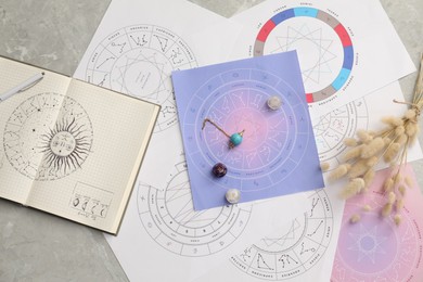 Photo of Natal chart for making forecast of fate and astrological items for fortune telling on light grey marble table, flat lay