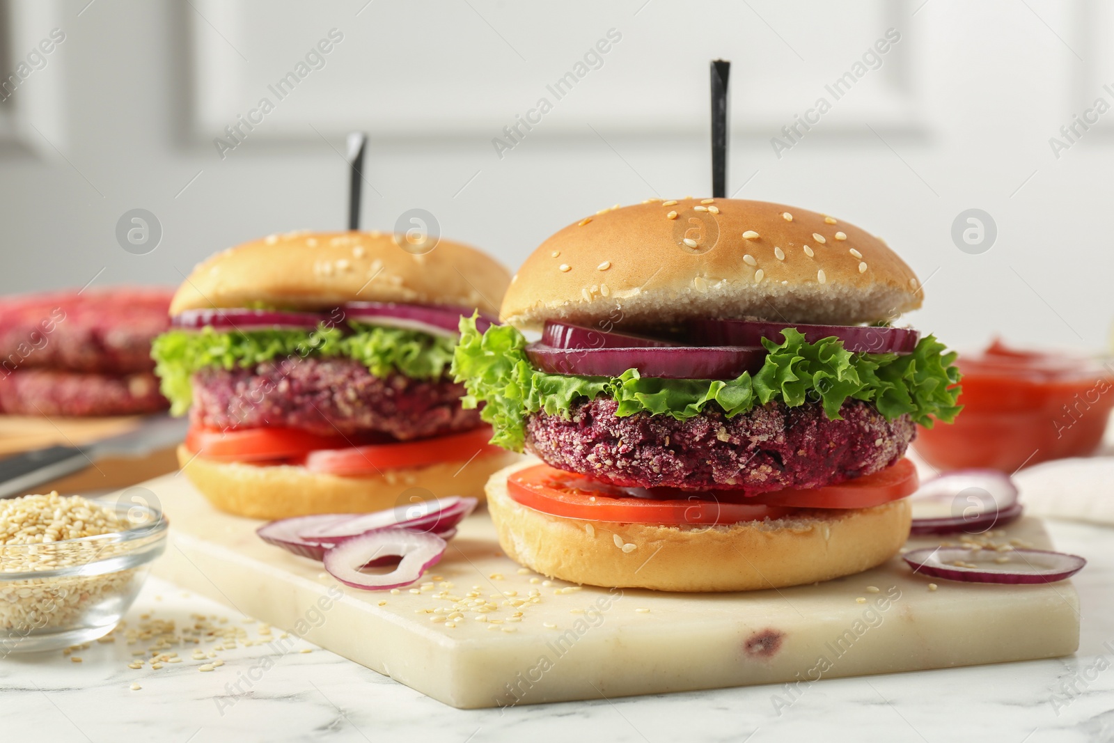 Photo of Tasty vegetarian burgers with beet patties on white marble table, closeup