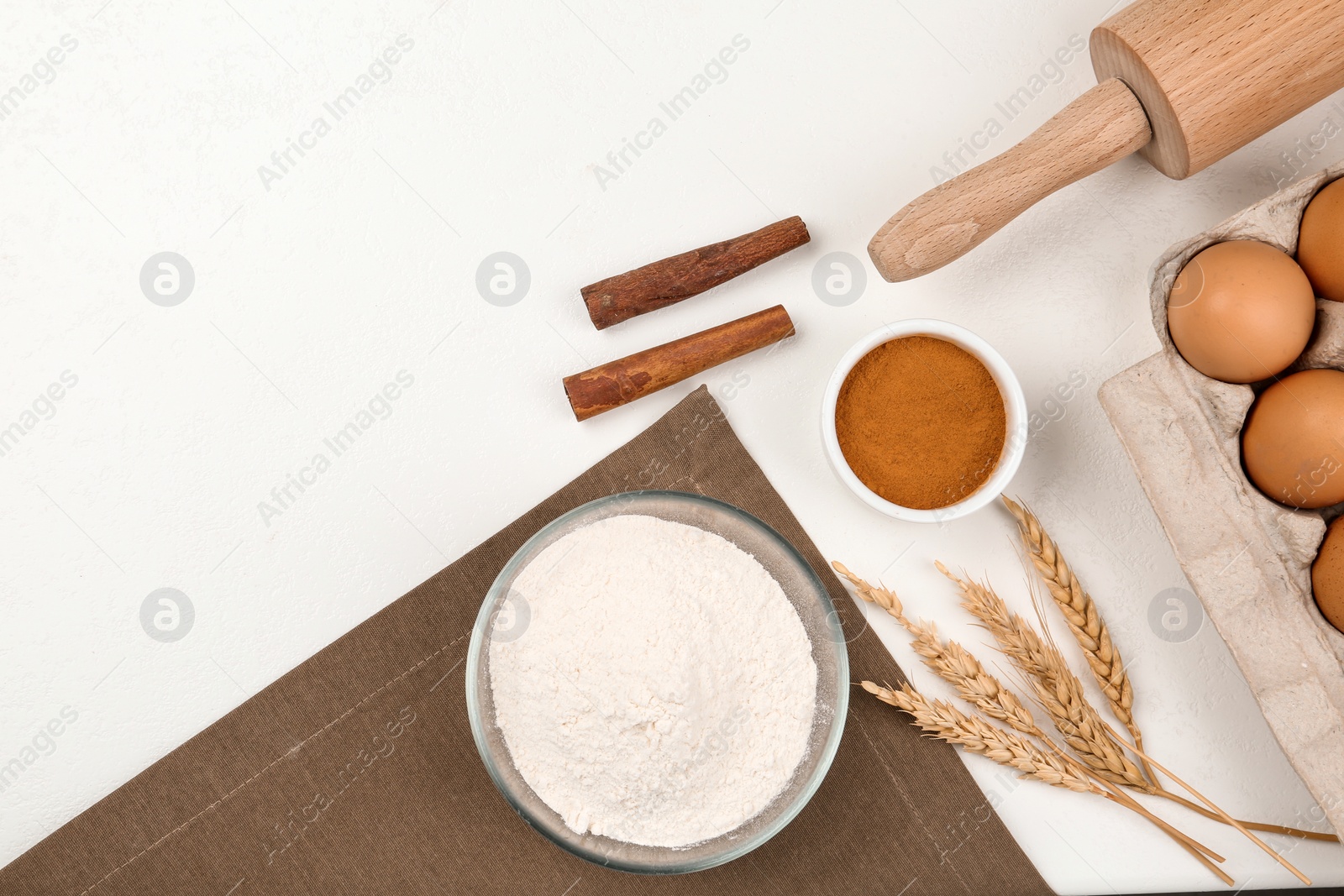 Photo of Flat lay composition with raw eggs and other ingredients on white table. Baking pie