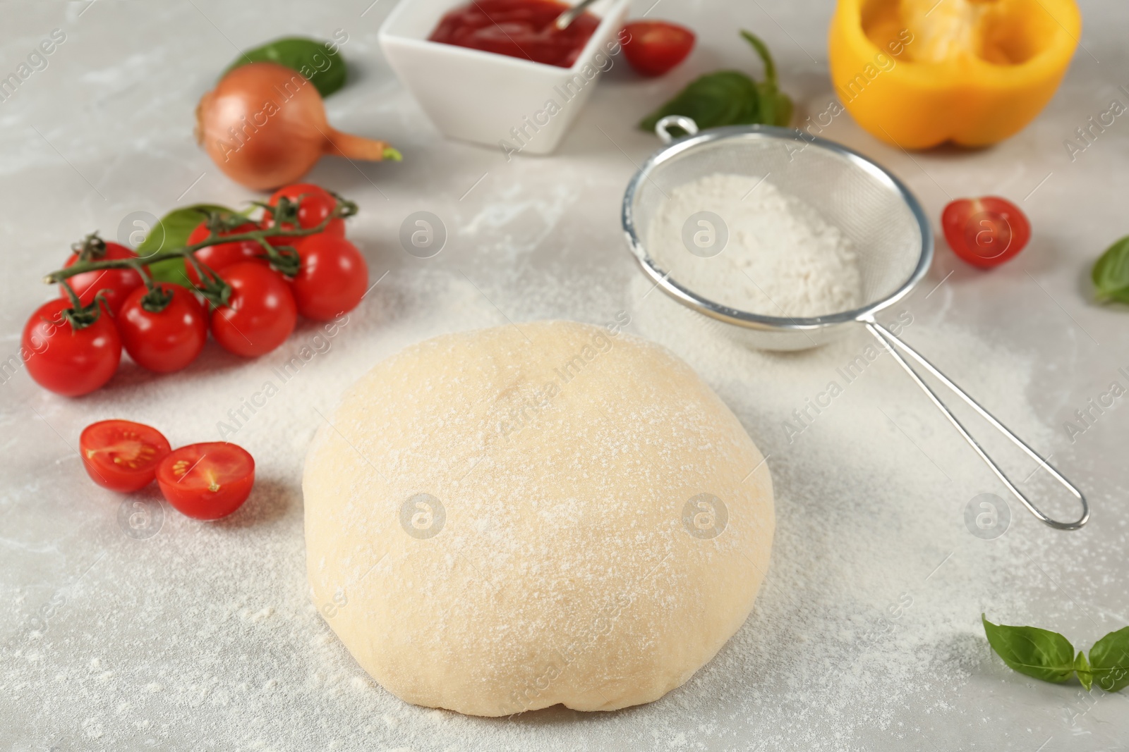 Photo of Fresh dough and ingredients for pizza on table