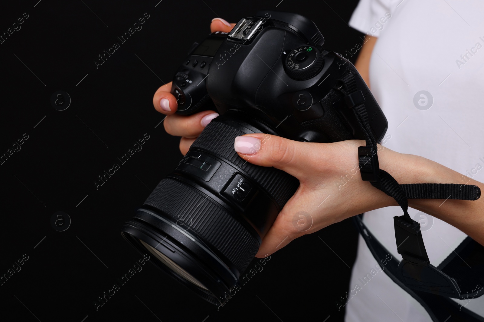 Photo of Photographer with camera on black background, closeup