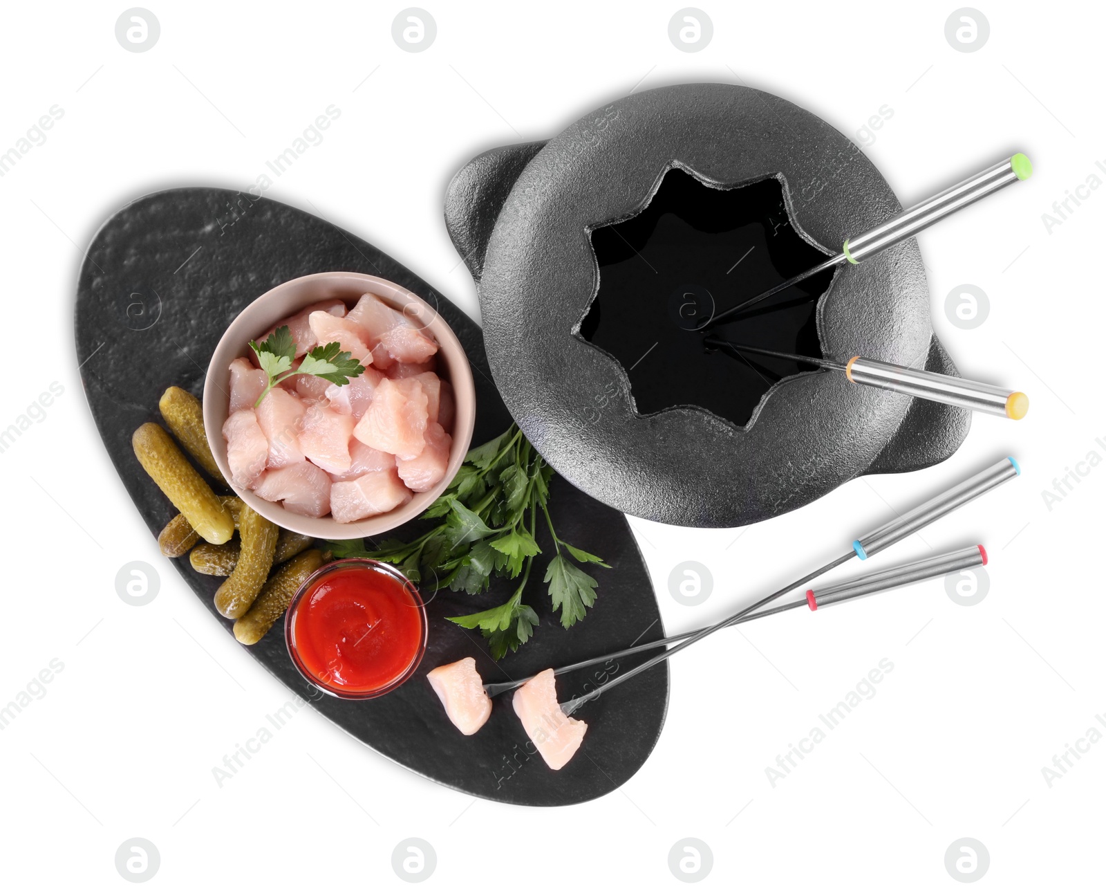 Photo of Fondue pot with oil, forks, raw meat pieces and other products isolated on white, top view