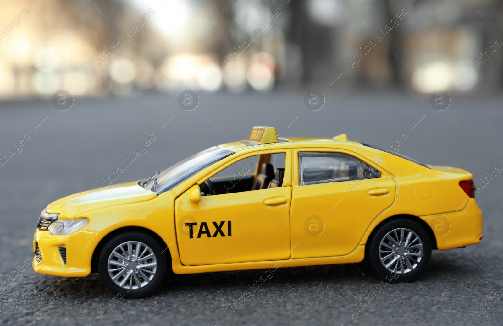 Photo of Yellow taxi car model on city street