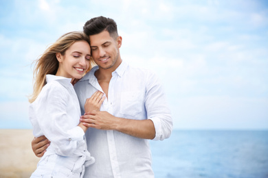 Photo of Happy couple on beach, space for text. Romantic walk