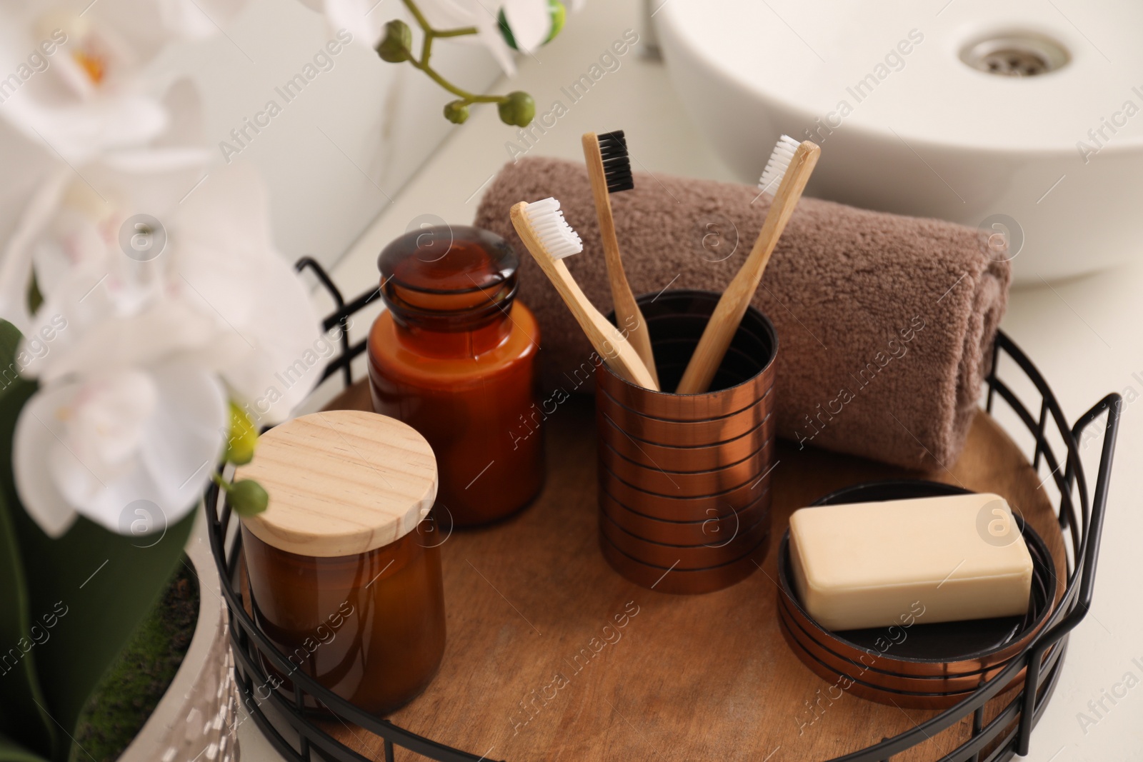 Photo of Tray with different toiletries on countertop in bathroom