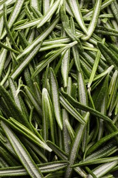 Photo of Pile of fresh green rosemary leaves as background, top view