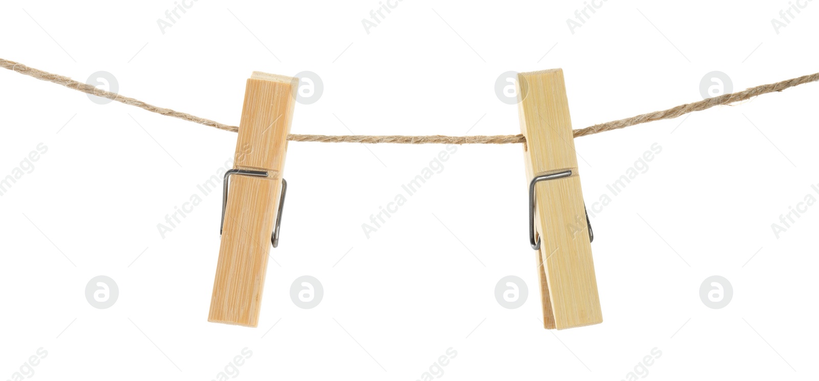 Photo of Two wooden clothespins on rope against white background