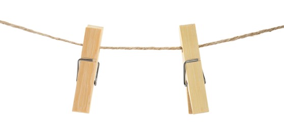Photo of Two wooden clothespins on rope against white background