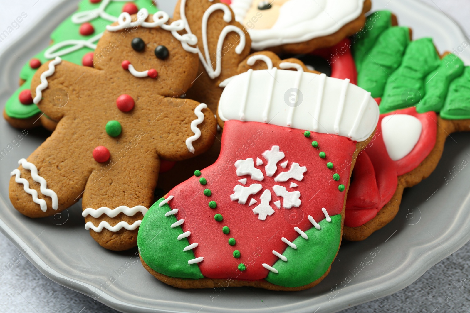 Photo of Tasty homemade Christmas cookies on light grey table, closeup