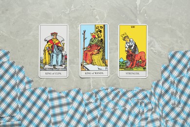 Tarot cards on light grey marble table, flat lay