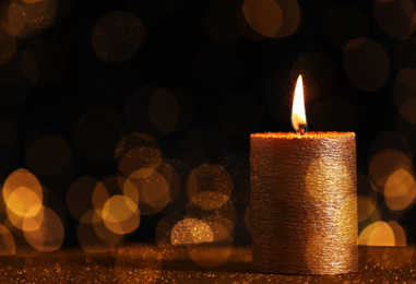 Image of Burning candle on dark background, bokeh effect