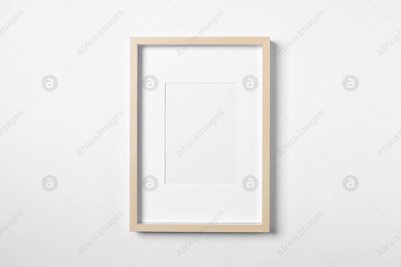 Photo of Empty wooden frame on white background. Mockup for design