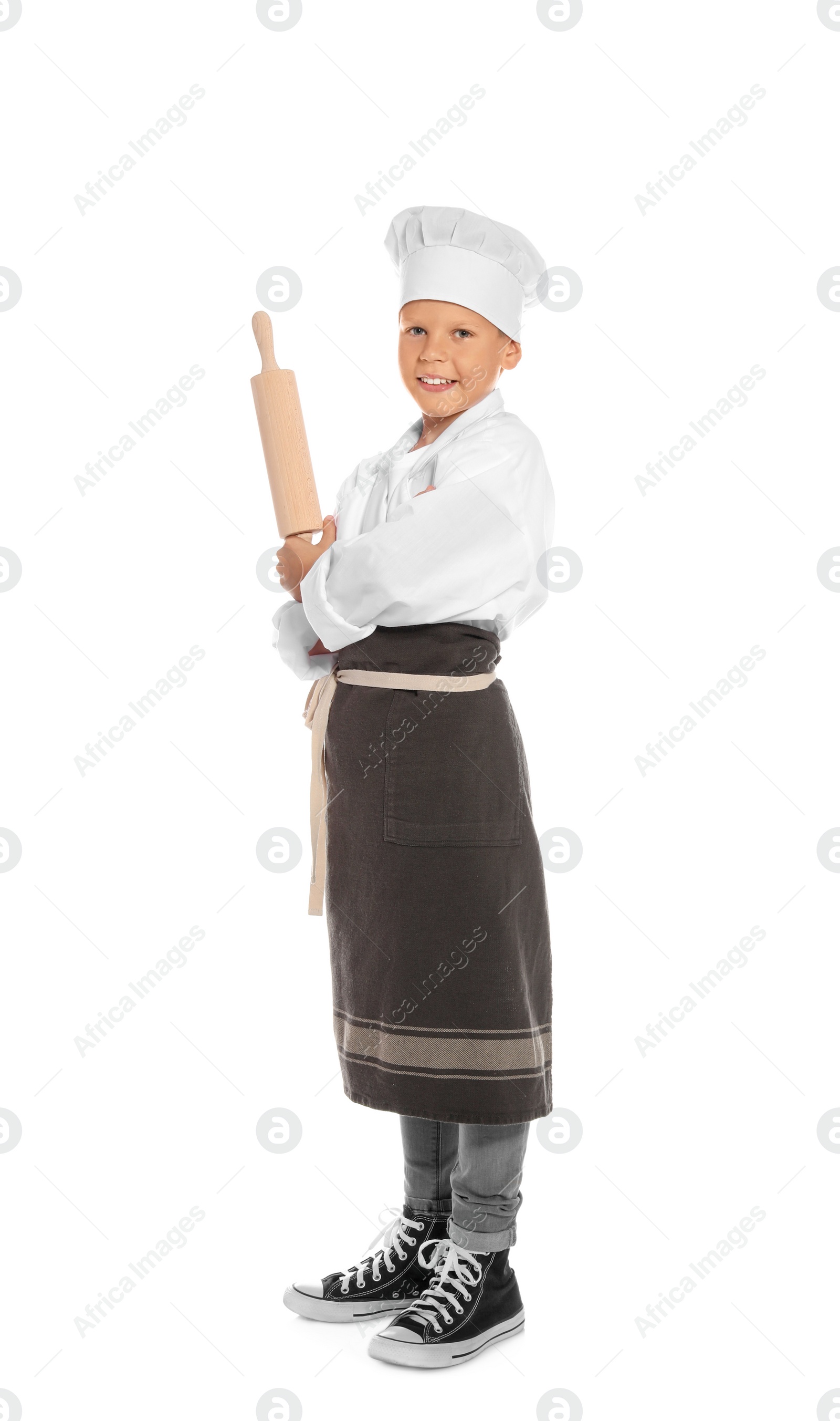 Photo of Full length portrait of little boy in chef hat with rolling pin on white background