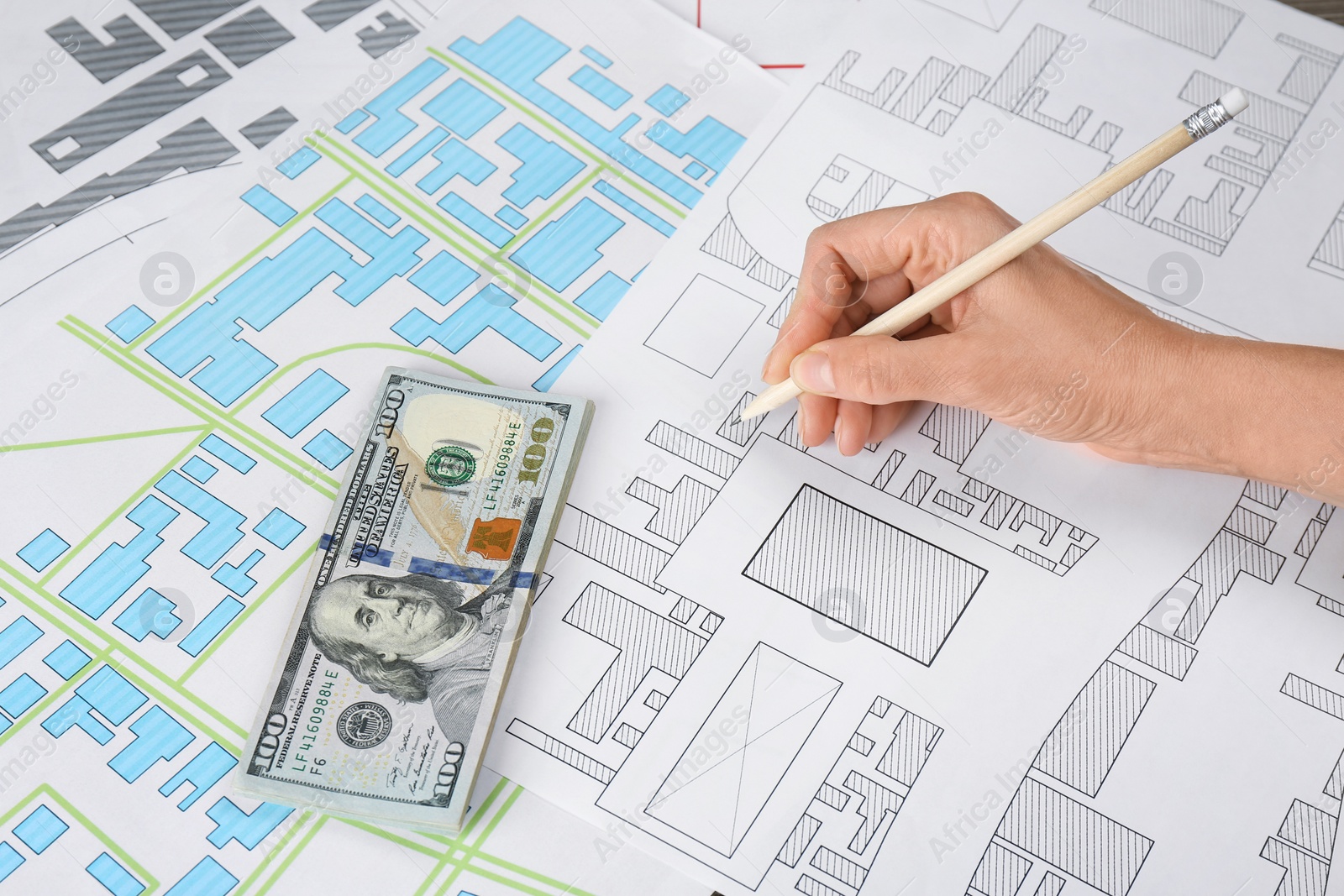 Photo of Cartographer with money drawing cadastral map, closeup