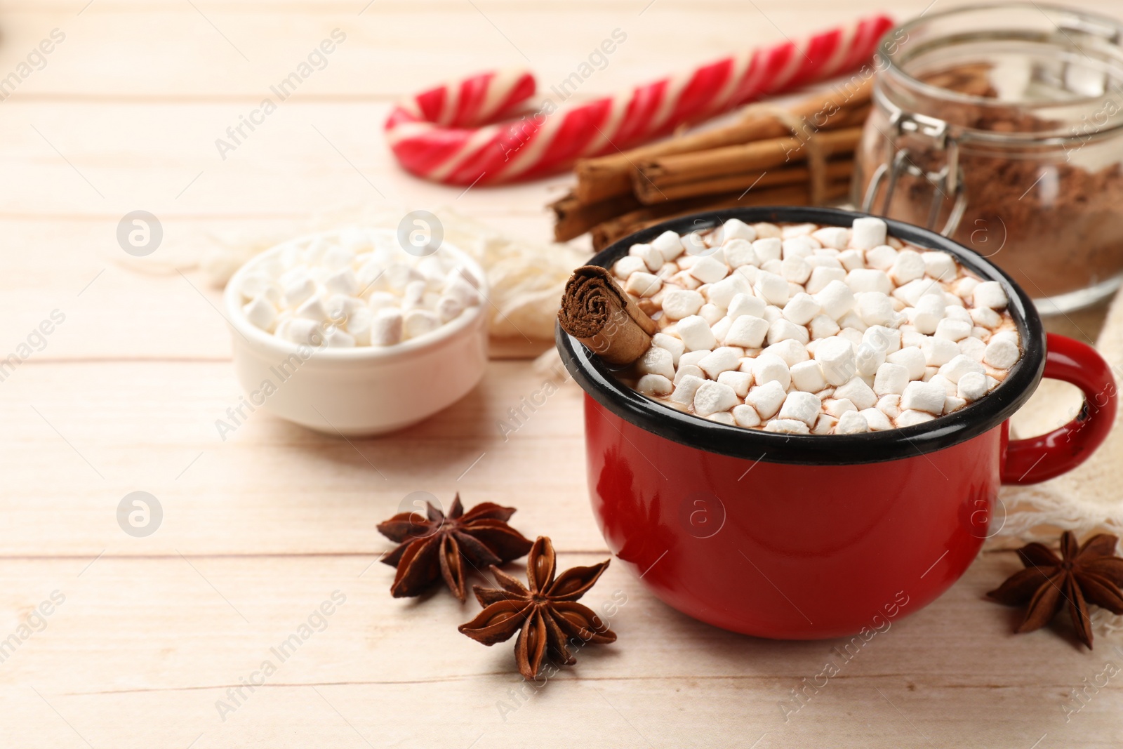 Photo of Tasty hot chocolate with marshmallows on white wooden table, closeup. Space for text