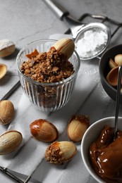 Photo of Delicious walnut shaped cookies with condensed milk on grey table, closeup